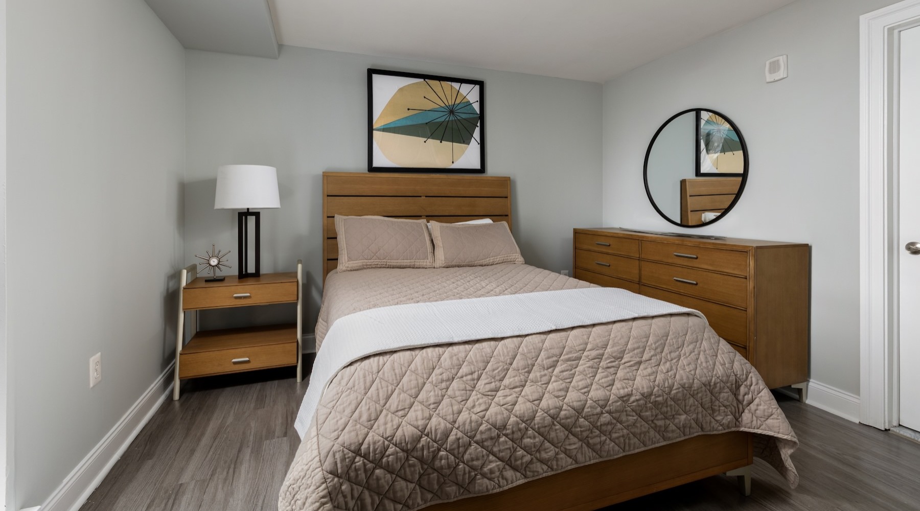 a bedroom with a bed and a dresser