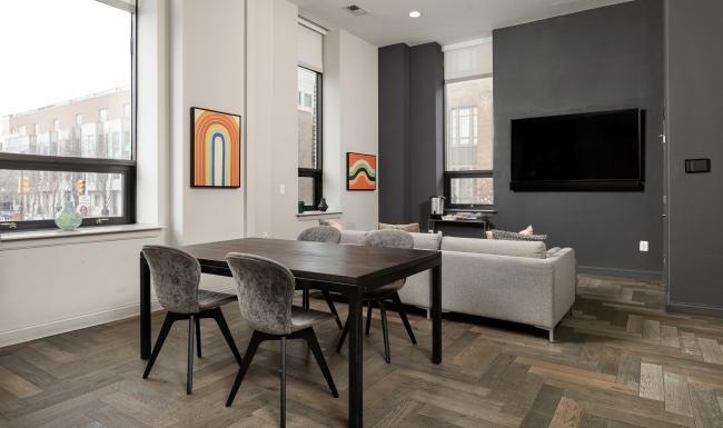 a clubroom with a tv, couch, table and chairs