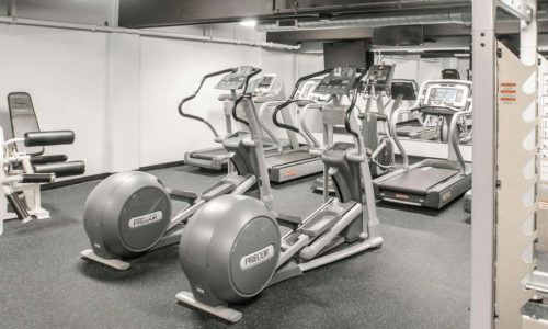 Fitness center with treadmills and elliptical machines at The Pepper Building